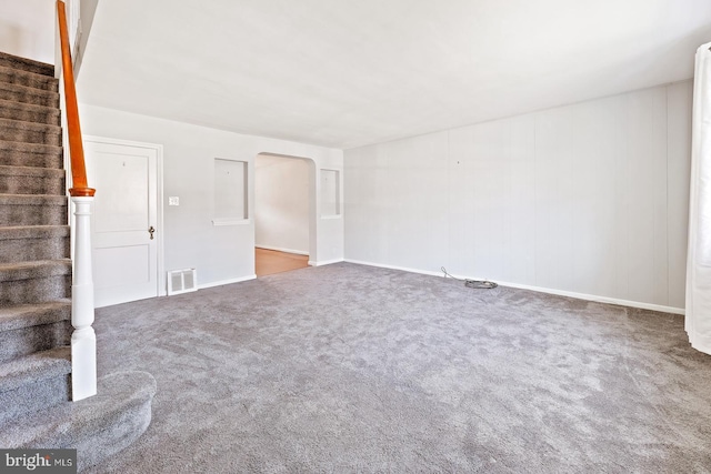 7155 Erdrick St, Philadelphia, PA 19135 - unfurnished living room featuring stairs, carpet flooring, and baseboards