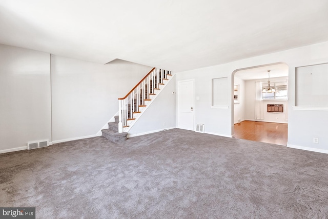 7155 Erdrick St, Philadelphia, PA 19135 - unfurnished living room featuring carpet, a chandelier, stairway, and baseboards
