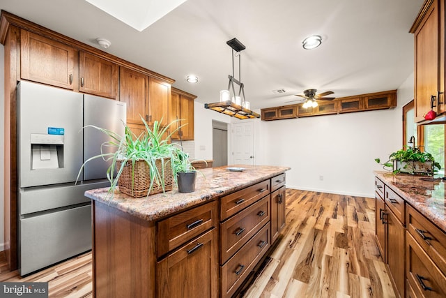 2460 Mill Rd, Quakertown, PA 18951 - kitchen with stainless steel refrigerator with ice dispenser, ceiling fan, light stone counters, brown cabinetry, and recessed lighting