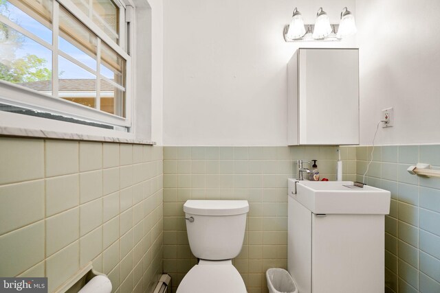 2460 Mill Rd, Quakertown, PA 18951 - half bathroom featuring tile walls, toilet, wainscoting, and vanity