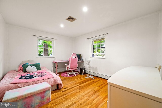 2460 Mill Rd, Quakertown, PA 18951 - bedroom featuring a baseboard heating unit, multiple windows, light wood-type flooring, and recessed lighting