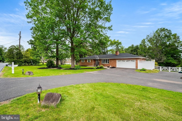 2460 Mill Rd, Quakertown, PA 18951 - ranch-style house featuring a garage, driveway, a chimney, and brick siding