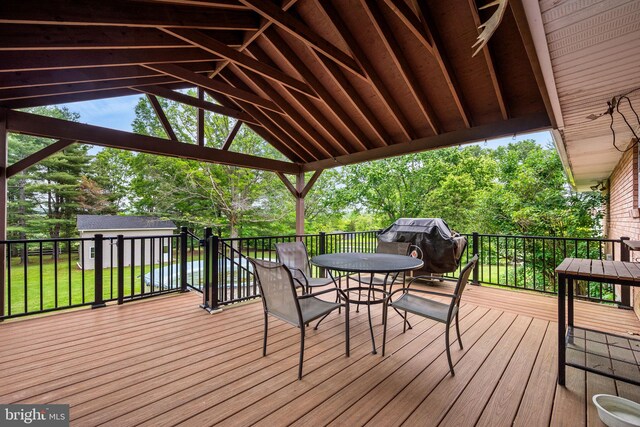 2460 Mill Rd, Quakertown, PA 18951 - deck featuring outdoor dining space, an outdoor structure, view of scattered trees, and a lawn