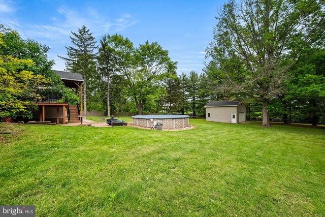 2460 Mill Rd, Quakertown, PA 18951 - view of green lawn featuring stairs, a wooden deck, an outdoor pool, and view of scattered trees