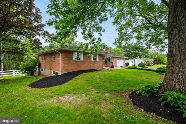 2460 Mill Rd, Quakertown, PA 18951 - back of property featuring a chimney, brick siding, and an attached garage