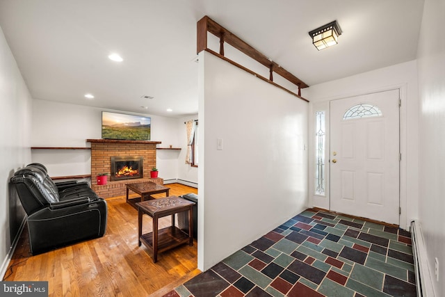 2460 Mill Rd, Quakertown, PA 18951 - entryway with baseboard heating, a baseboard radiator, a fireplace, recessed lighting, and wood finished floors