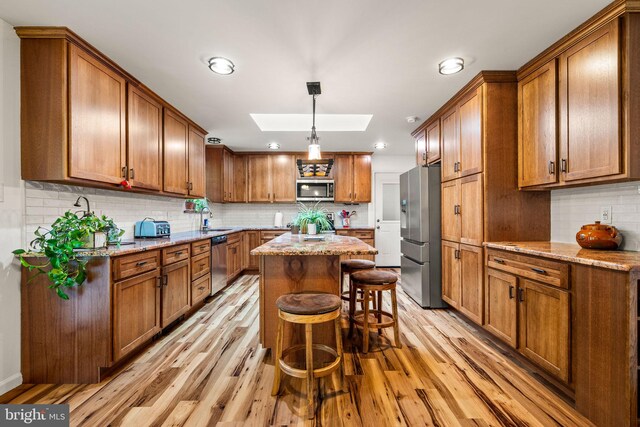 2460 Mill Rd, Quakertown, PA 18951 - kitchen with appliances with stainless steel finishes, a skylight, brown cabinetry, and recessed lighting