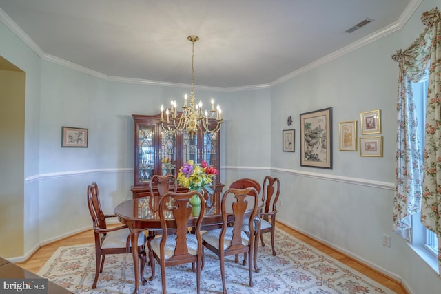 636 Poets Way, Middletown, DE 19709 - dining room featuring a chandelier, wood finished floors, and crown molding