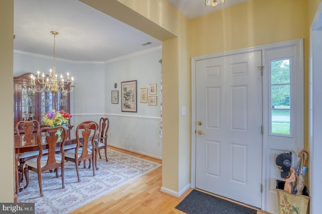 636 Poets Way, Middletown, DE 19709 - foyer entrance with a chandelier, wood finished floors, and ornamental molding