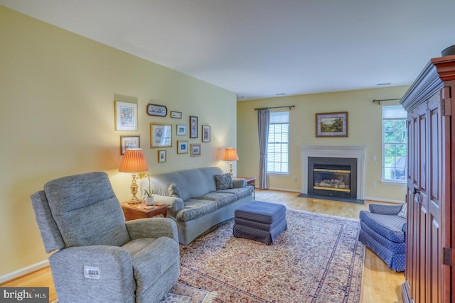 636 Poets Way, Middletown, DE 19709 - living room featuring plenty of natural light, light wood-style floors, a fireplace with flush hearth, and baseboards