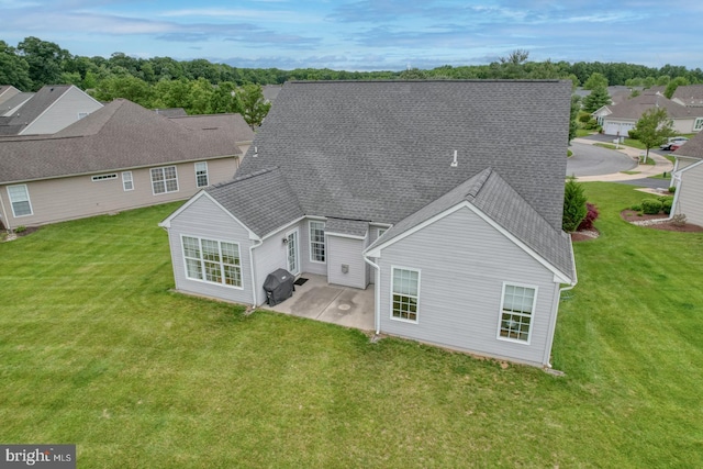 636 Poets Way, Middletown, DE 19709 - back of house with a patio area, a lawn, and a shingled roof
