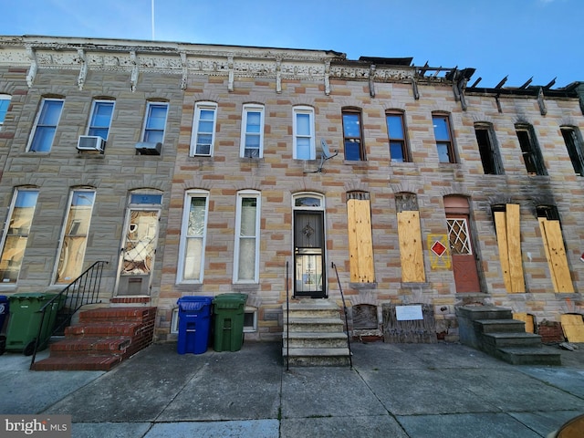 329 S Calhoun St, Baltimore, MD 21223 - view of property with entry steps, stone siding, and cooling unit