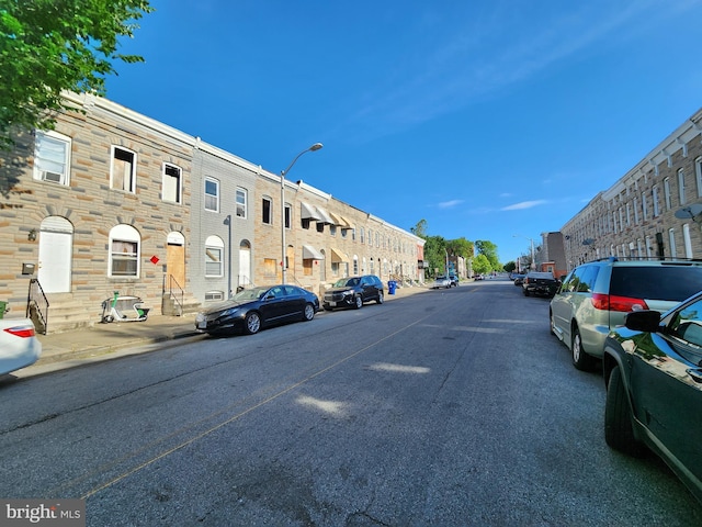 329 S Calhoun St, Baltimore, MD 21223 - view of asphalt road with street lights, curbs, sidewalks, and a residential view
