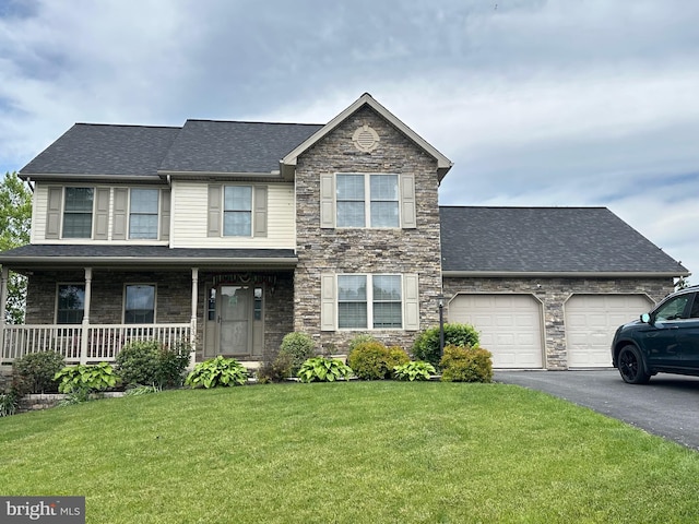 133 Granny Smith Ln, Fayetteville, PA 17222 - view of front facade with driveway, a front yard, an attached garage, stone siding, and covered porch