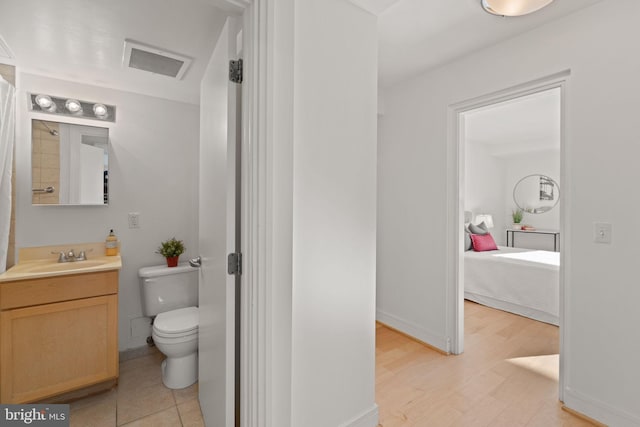 800 4th St SW Unit N216, Washington, DC 20024 - full bathroom with vanity, toilet, ensuite bath, baseboards, and wood finished floors