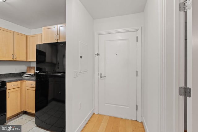 800 4th St SW Unit N216, Washington, DC 20024 - kitchen featuring freestanding refrigerator, light brown cabinetry, dark countertops, stove, and baseboards