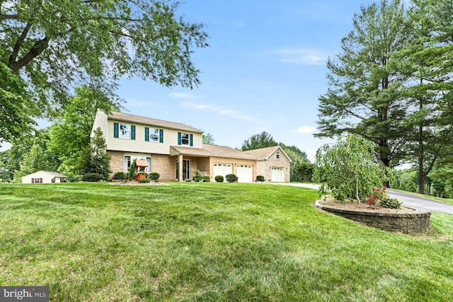 536 Dawson Trak, Hockessin, DE 19707 - view of front of property featuring a garage, a front yard, brick siding, and driveway