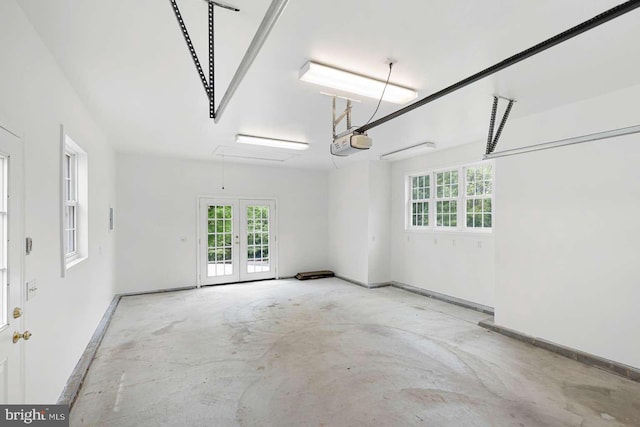 536 Dawson Trak, Hockessin, DE 19707 - garage with french doors, a garage door opener, and baseboards