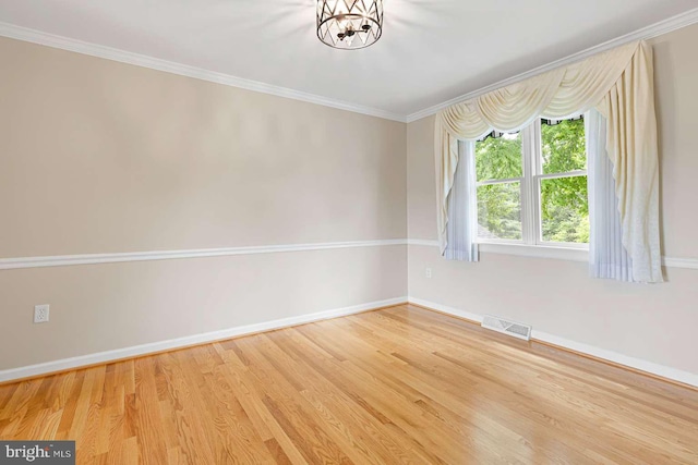 536 Dawson Trak, Hockessin, DE 19707 - unfurnished room featuring baseboards, wood finished floors, ornamental molding, and a chandelier