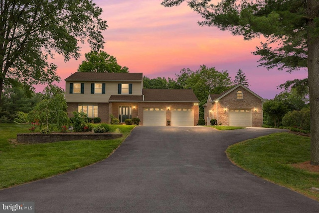 536 Dawson Trak, Hockessin, DE 19707 - traditional-style house with brick siding, an attached garage, asphalt driveway, and a front lawn