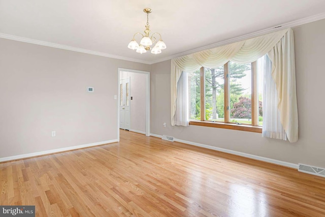 536 Dawson Trak, Hockessin, DE 19707 - spare room featuring a chandelier, baseboards, crown molding, and light wood-style flooring