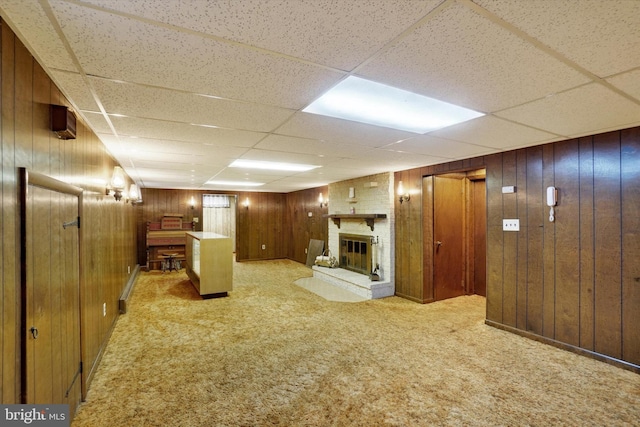 144 Ridgeview Rd, Seven Valleys, PA 17360 - finished basement featuring a brick fireplace, wood walls, a paneled ceiling, and light carpet