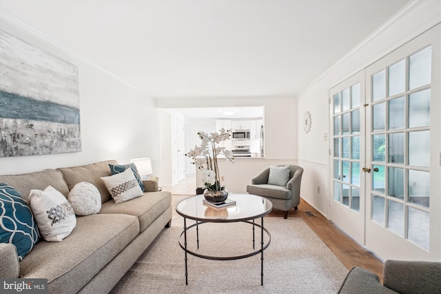 944 War Admiral St, Great Falls, VA 22066 - living area featuring wood finished floors, ornamental molding, and french doors