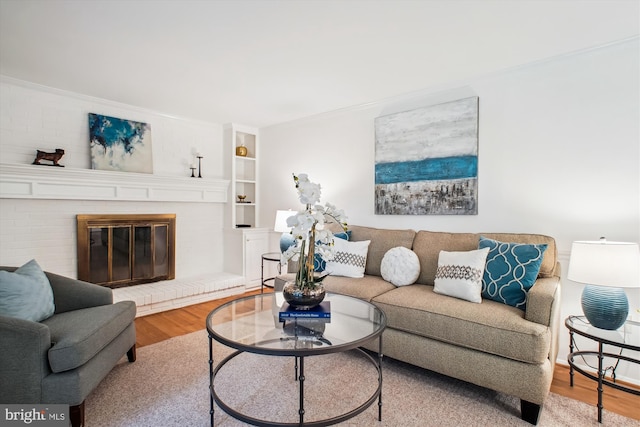 944 War Admiral St, Great Falls, VA 22066 - living area featuring wood finished floors, crown molding, and a brick fireplace