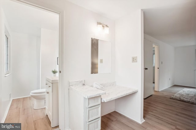 944 War Admiral St, Great Falls, VA 22066 - bathroom with toilet, wood finished floors, vanity, and baseboards