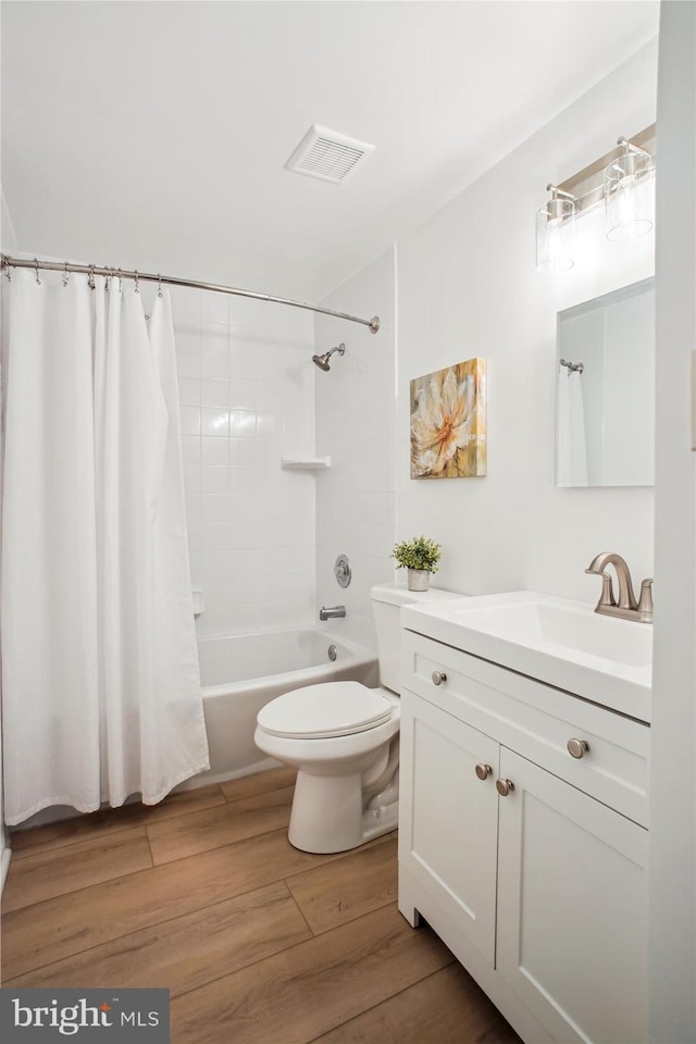 944 War Admiral St, Great Falls, VA 22066 - full bath featuring vanity, shower / bath combo with shower curtain, wood finished floors, and toilet