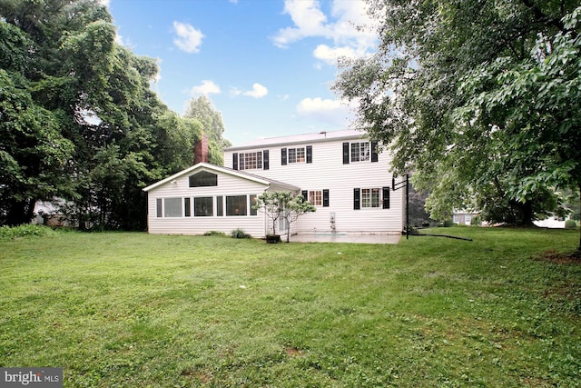 944 War Admiral St, Great Falls, VA 22066 - rear view of house with a patio area, a lawn, and a chimney