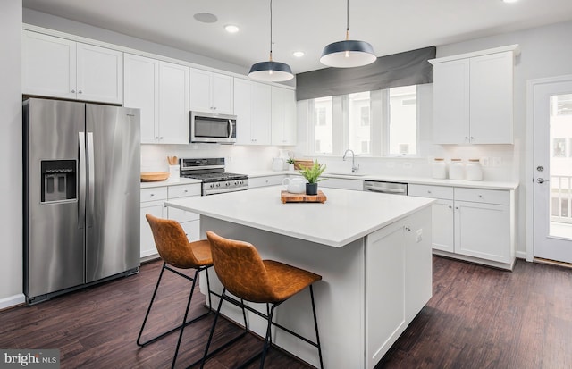 1205 Bear Oak Ln, Laurel, MD 20724 - kitchen with appliances with stainless steel finishes, recessed lighting, white cabinets, a kitchen island, and dark wood finished floors