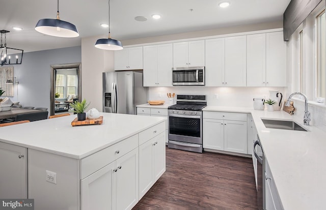 1205 Bear Oak Ln, Laurel, MD 20724 - kitchen with appliances with stainless steel finishes, a sink, white cabinetry, dark wood-type flooring, and light countertops