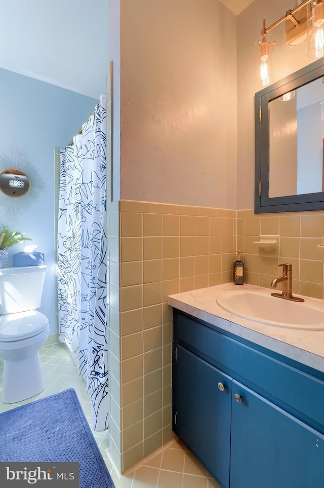 80 School House Rd, Lancaster, PA 17603 - bathroom featuring vanity, toilet, tile patterned floors, tile walls, and a shower with shower curtain
