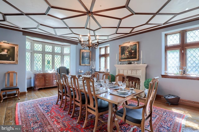80 School House Rd, Lancaster, PA 17603 - dining room featuring wood-type flooring, coffered ceiling, a chandelier, baseboards, and a fireplace