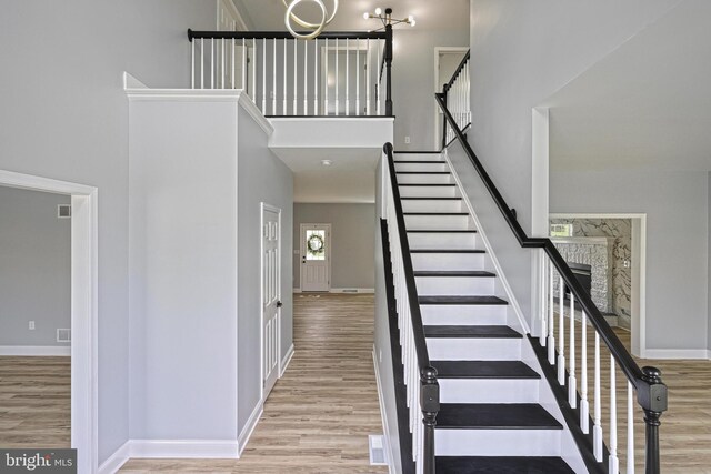 1201 Falls Grove Ln, York, PA 17404 - stairway with wood finished floors, a high ceiling, and baseboards