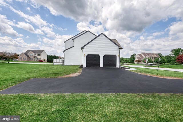 1201 Falls Grove Ln, York, PA 17404 - view of side of property with asphalt driveway, a yard, and a garage