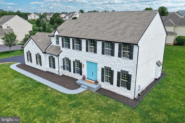 1201 Falls Grove Ln, York, PA 17404 - colonial home featuring stone siding, a front lawn, and roof with shingles