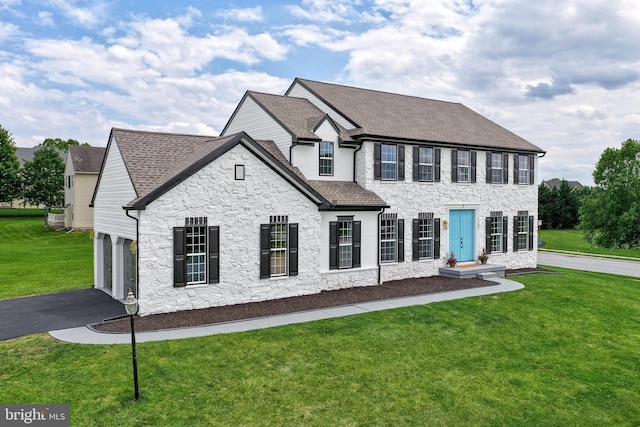 1201 Falls Grove Ln, York, PA 17404 - view of front facade with stone siding, roof with shingles, asphalt driveway, and a front yard