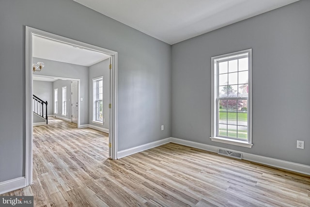 1201 Falls Grove Ln, York, PA 17404 - spare room featuring healthy amount of natural light, stairway, and light wood-style floors