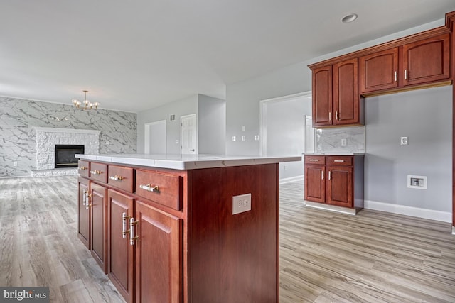 1201 Falls Grove Ln, York, PA 17404 - kitchen featuring light wood-type flooring, light countertops, open floor plan, and a chandelier