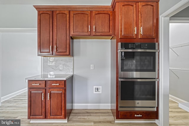 1201 Falls Grove Ln, York, PA 17404 - kitchen featuring stainless steel double oven, light wood-type flooring, baseboards, and tasteful backsplash