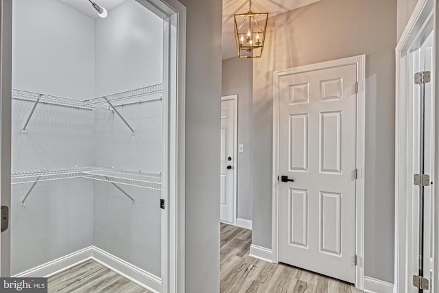 1201 Falls Grove Ln, York, PA 17404 - walk in closet with a chandelier and light wood-style floors