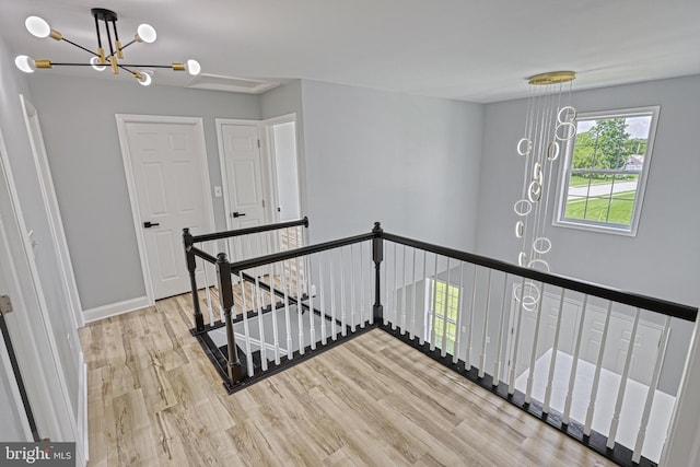 1201 Falls Grove Ln, York, PA 17404 - staircase with a chandelier, wood finished floors, and baseboards