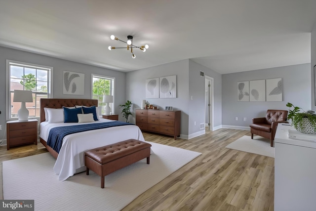 1201 Falls Grove Ln, York, PA 17404 - bedroom featuring a chandelier, light wood finished floors, and baseboards