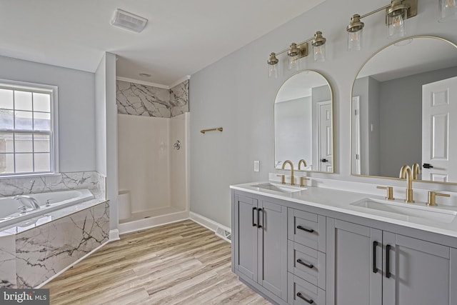 1201 Falls Grove Ln, York, PA 17404 - full bathroom featuring double vanity, a bath, a shower, wood finished floors, and baseboards