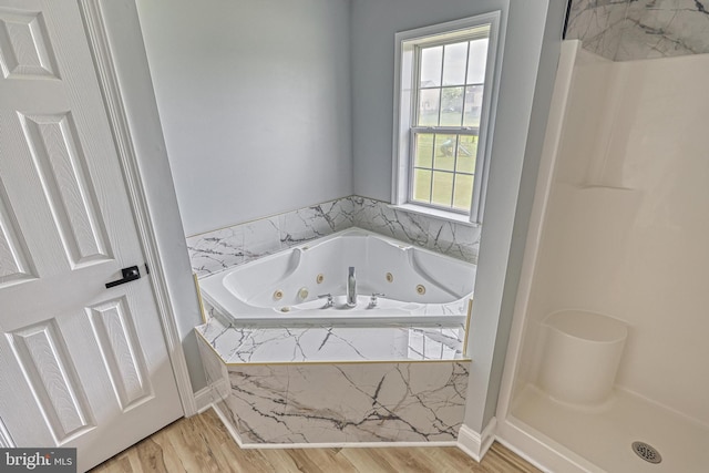 1201 Falls Grove Ln, York, PA 17404 - bathroom with wood finished floors, a tub with jets, and a shower