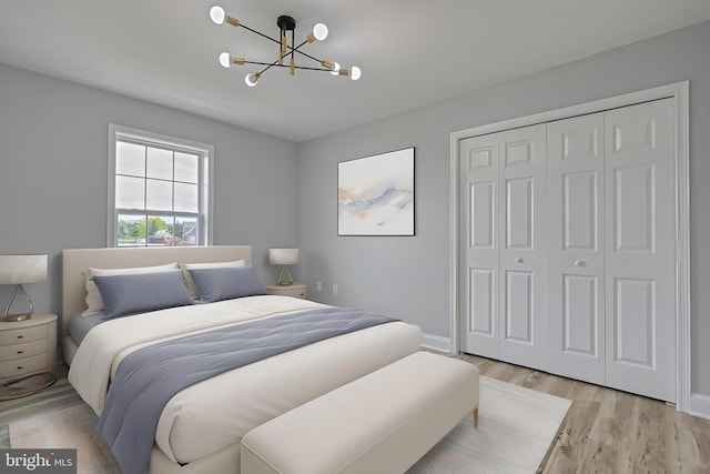 1201 Falls Grove Ln, York, PA 17404 - bedroom with a chandelier, light wood-style floors, a closet, and baseboards
