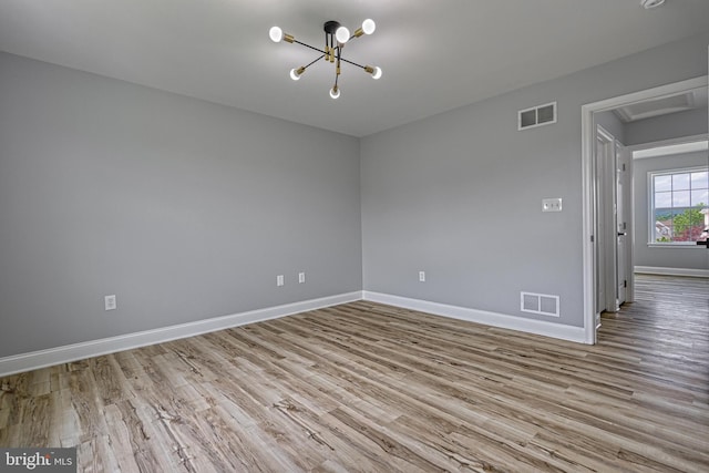 1201 Falls Grove Ln, York, PA 17404 - unfurnished room featuring wood finished floors, a chandelier, baseboards, and attic access