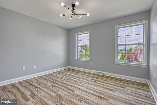 1201 Falls Grove Ln, York, PA 17404 - spare room with a chandelier, light wood-style floors, and baseboards